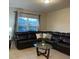 Comfortable living room with a large sectional sofa, stylish coffee table, and natural light at 1749 Fulfillment Dr, Kissimmee, FL 34744