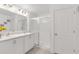 Bathroom with double sink vanity, white cabinets, and a glass-enclosed shower at 1877 River Crest Ave, St Cloud, FL 34771