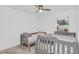 Bedroom with twin beds, carpet flooring, a ceiling fan, and a window at 1877 River Crest Ave, St Cloud, FL 34771