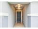 Covered entryway featuring a gray front door with stylish lighting and a textured exterior at 1877 River Crest Ave, St Cloud, FL 34771
