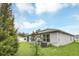 Side exterior view of the house and large backyard with lush green lawn at 1877 River Crest Ave, St Cloud, FL 34771