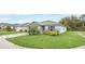 Single-story home with a lush green lawn, and a two-car garage, set in a quiet neighborhood at 1877 River Crest Ave, St Cloud, FL 34771
