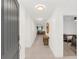 Inviting hallway with light tile flooring, modern lighting, and views of the living area and bedroom at 1877 River Crest Ave, St Cloud, FL 34771