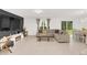 Bright and airy living room featuring a large sectional sofa, stylish decor, and a view of the dining area at 1877 River Crest Ave, St Cloud, FL 34771