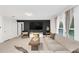 Modern living room with a large TV, comfortable seating, and bright natural light, enhanced by stylish decor at 1877 River Crest Ave, St Cloud, FL 34771
