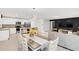Spacious open-concept living room with an adjacent dining area and modern kitchen with stainless appliances at 1877 River Crest Ave, St Cloud, FL 34771