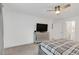 Main bedroom featuring a dresser with a TV and an ensuite bathroom at 1877 River Crest Ave, St Cloud, FL 34771