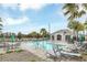 Resort-style pool with lounge chairs, umbrellas, and a covered pavilion in a community setting at 1877 River Crest Ave, St Cloud, FL 34771