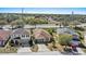 An aerial view of a well-maintained home with a driveway, landscaping, and a location near a highway at 217 Sand Ridge Dr, Davenport, FL 33896
