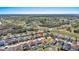 An aerial view shows a neighborhood with a home near roadways and recreational green spaces at 217 Sand Ridge Dr, Davenport, FL 33896