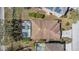 Aerial view of a house featuring a screened pool in a sunny residential neighborhood at 217 Sand Ridge Dr, Davenport, FL 33896