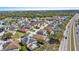 An aerial view captures a densely populated neighborhood near a conservation area at 217 Sand Ridge Dr, Davenport, FL 33896