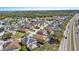 A high aerial view highlights homes in a community near conservation and roadways at 217 Sand Ridge Dr, Davenport, FL 33896