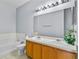 Spacious bathroom with dual sinks, large mirror, and a separate tub at 217 Sand Ridge Dr, Davenport, FL 33896