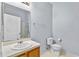 Bright bathroom with a single sink and a toilet at 217 Sand Ridge Dr, Davenport, FL 33896