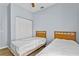 Bright bedroom features two twin beds and wood-look flooring at 217 Sand Ridge Dr, Davenport, FL 33896