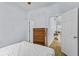 Cozy bedroom with wood floors, a dresser, and a view into the living room at 217 Sand Ridge Dr, Davenport, FL 33896