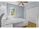 Cozy bedroom featuring wood-look floors, a ceiling fan, a window, and a closet at 217 Sand Ridge Dr, Davenport, FL 33896