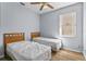 Bright bedroom with two twin beds, ceiling fan, and wood-look flooring at 217 Sand Ridge Dr, Davenport, FL 33896