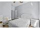 Bright bedroom with wood-look flooring, a white bed, white dressers, and a mirror at 217 Sand Ridge Dr, Davenport, FL 33896