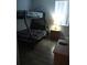 This cozy bedroom features bunk beds, dark wood floors, and warm natural lighting at 217 Sand Ridge Dr, Davenport, FL 33896