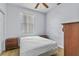 A simple bedroom with wood floors, a bed, and matching nightstands with ceiling fan at 217 Sand Ridge Dr, Davenport, FL 33896