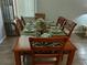 Formal dining room showcases a wooden table with six chairs, complete with elegant place settings for sophisticated dining at 217 Sand Ridge Dr, Davenport, FL 33896