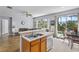 Open-concept kitchen with stainless appliances overlooking a dining area and screened pool at 217 Sand Ridge Dr, Davenport, FL 33896