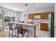 Eat-in kitchen features stainless appliances, bright countertops, and breakfast bar with backyard views at 217 Sand Ridge Dr, Davenport, FL 33896