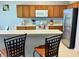 This modern kitchen features stainless steel appliances, light wood cabinets, and bar seating at 217 Sand Ridge Dr, Davenport, FL 33896