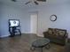 This cozy living room features tile flooring, a ceiling fan, and comfortable seating at 217 Sand Ridge Dr, Davenport, FL 33896