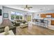 Living room features a comfortable sofa, breakfast bar seating, and a sun room in the background at 217 Sand Ridge Dr, Davenport, FL 33896