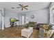 Cozy living room featuring wood floors, ceiling fan, and comfortable seating arrangement at 217 Sand Ridge Dr, Davenport, FL 33896