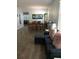 Open-concept living and dining area featuring tile floors and comfortable seating, perfect for entertaining and relaxation at 217 Sand Ridge Dr, Davenport, FL 33896