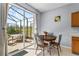 Breakfast nook features large glass doors leading out to a screened lanai and grassy backyard at 217 Sand Ridge Dr, Davenport, FL 33896