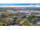 An aerial view shows the property with surrounding businesses and roads in a vibrant neighborhood at 3000 Maingate Ln # 205, Kissimmee, FL 34747