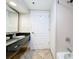 A modern bathroom with a granite counter, shower, and essential fixtures at 3000 Maingate Ln # 205, Kissimmee, FL 34747