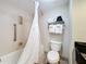 Bathroom featuring a bathtub with shower, toilet, and convenient towel rack at 3000 Maingate Ln # 205, Kissimmee, FL 34747