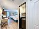 An interior view showing the bedroom's kitchenette with modern appliances and two beds at 3000 Maingate Ln # 205, Kissimmee, FL 34747