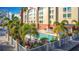 The outdoor swimming pool with lounge chairs and lush landscaping at this gorgeous hotel resort at 3000 Maingate Ln # 205, Kissimmee, FL 34747