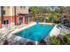 Outdoor swimming pool with lounge chairs and lush landscaping provides a tranquil and refreshing experience at 3000 Maingate Ln # 205, Kissimmee, FL 34747