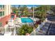 Outdoor swimming pool with seating and lush landscaping provides a relaxing and refreshing experience at 3000 Maingate Ln # 205, Kissimmee, FL 34747