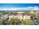 Front aerial view of the Galleria building surrounded by parking lot and palm trees at 3000 Maingate Ln # 424, Kissimmee, FL 34747