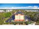 Back aerial view of the Galleria building showing the parking lot and surrounding trees at 3000 Maingate Ln # 424, Kissimmee, FL 34747