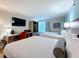 Comfortable bedroom with two queen beds, a desk, and a flat screen tv at 3000 Maingate Ln # 424, Kissimmee, FL 34747