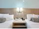 Two bed bedroom with a telephone and lamp on the nightstand at 3000 Maingate Ln # 424, Kissimmee, FL 34747
