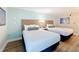Two bed bedroom with modern decor, offers bright natural light at 3000 Maingate Ln # 424, Kissimmee, FL 34747