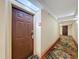 Hotel hallway featuring room doors and a decorative floral carpet at 3000 Maingate Ln # 424, Kissimmee, FL 34747