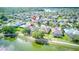 An aerial view of a neighborhood, showcasing a scenic pond and manicured lawns at 318 Rock Springs Dr, Poinciana, FL 34759