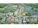 Aerial view of a neighborhood featuring mature trees, community pool, and multiple ponds at 318 Rock Springs Dr, Poinciana, FL 34759